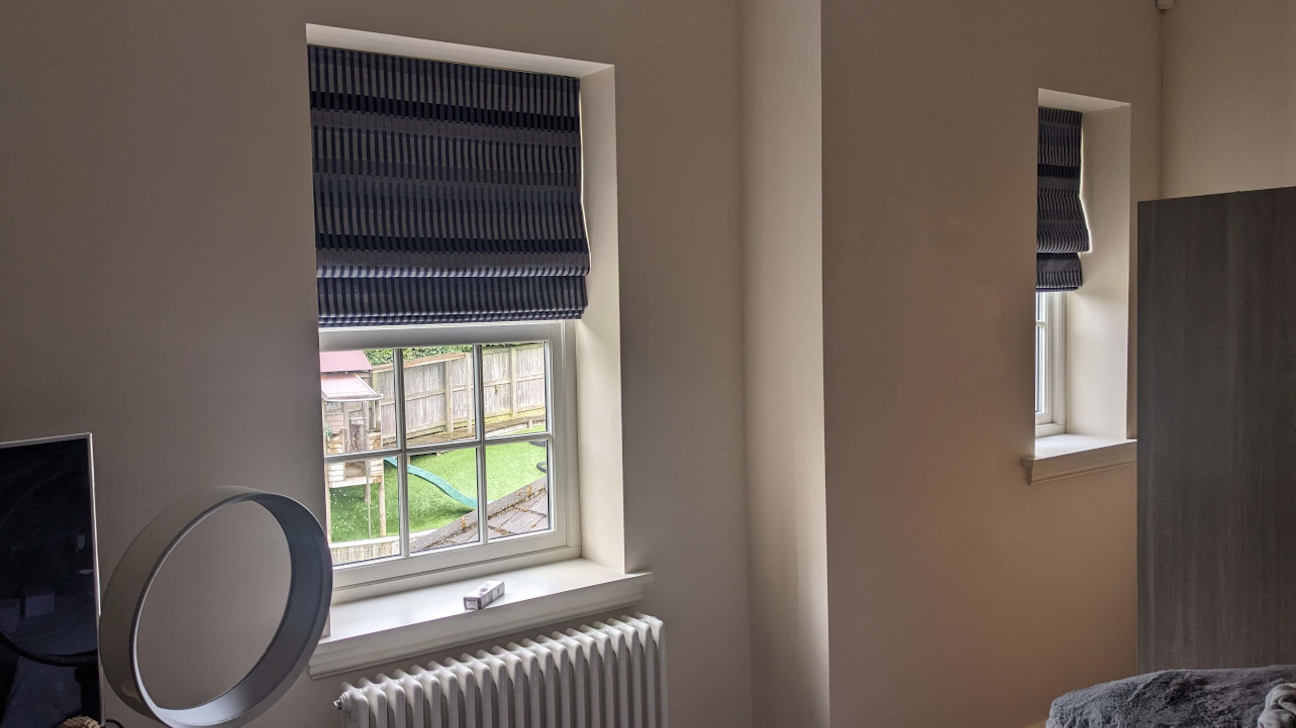 Modern living room with elegant custom Roman blinds