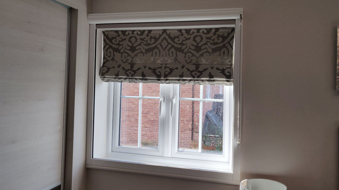 Living room showcasing custom Roman blinds