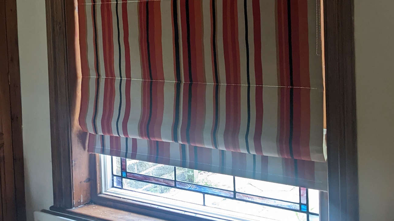 Hallway featuring custom Roman blinds