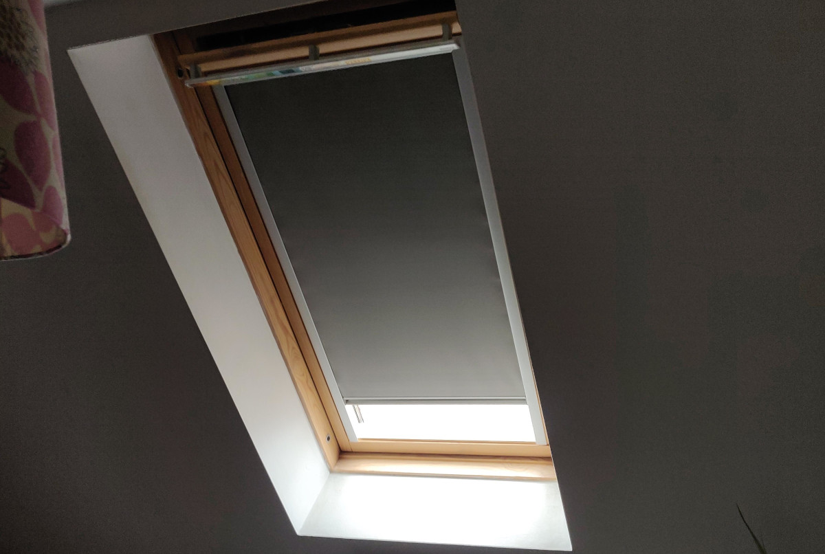 Custom skylight blinds in a stylish bedroom